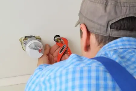 Plumber opening a pipe hole