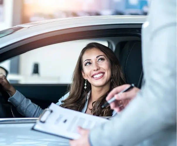 Woman receiving vehicle documents from an agent