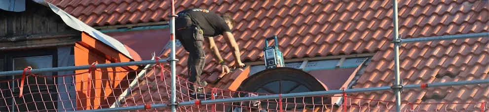 Roofing contractor working on a tiled roof