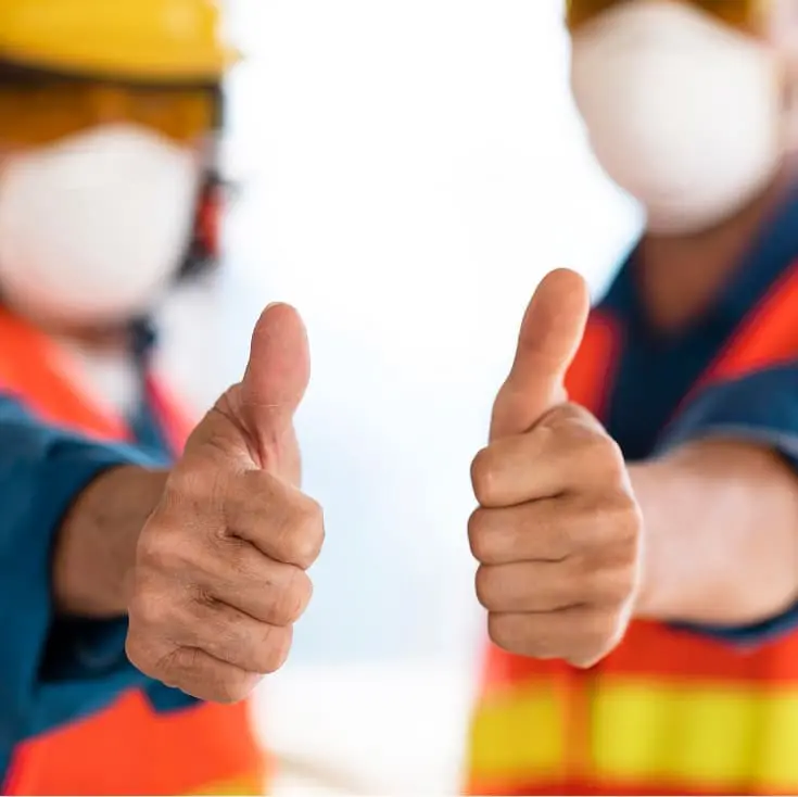 Construction workers giving thumbs up