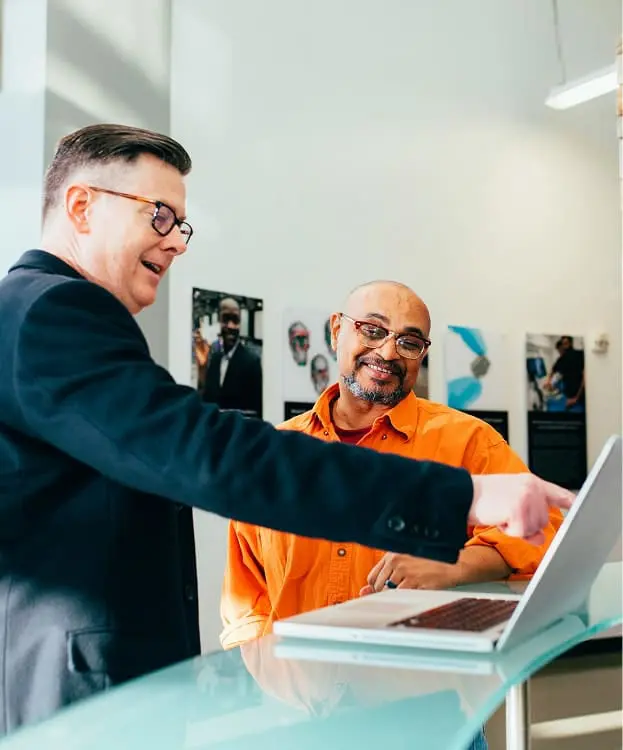 Contractors discussing plans at a laptop