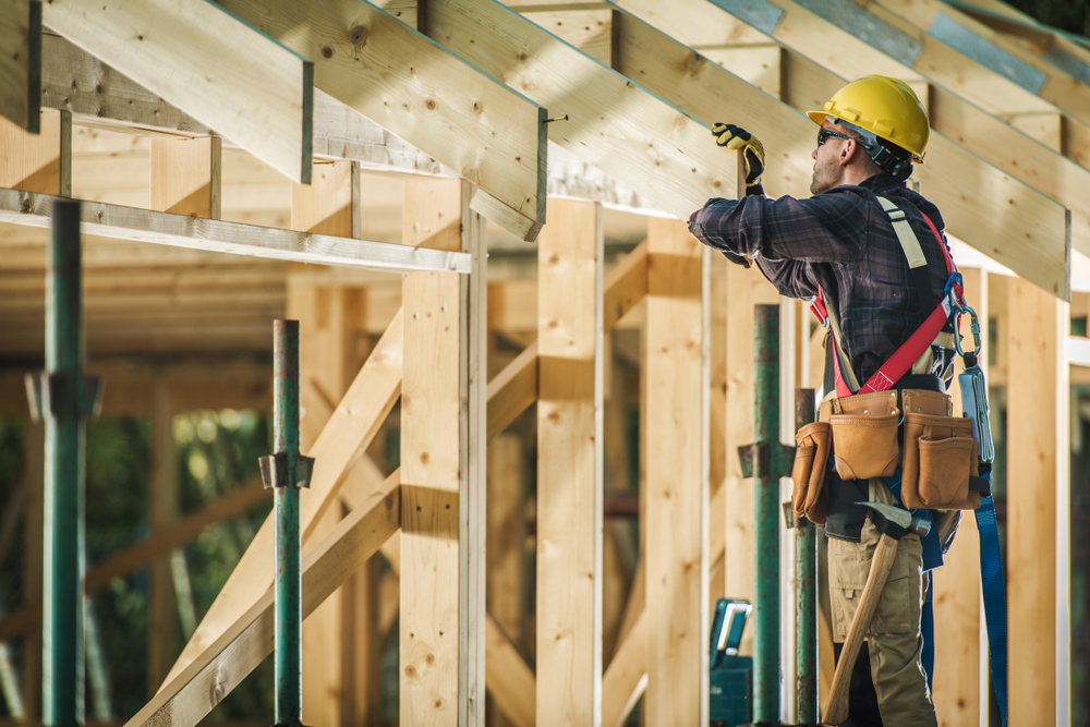 Carpenter adjusting a wooden beam