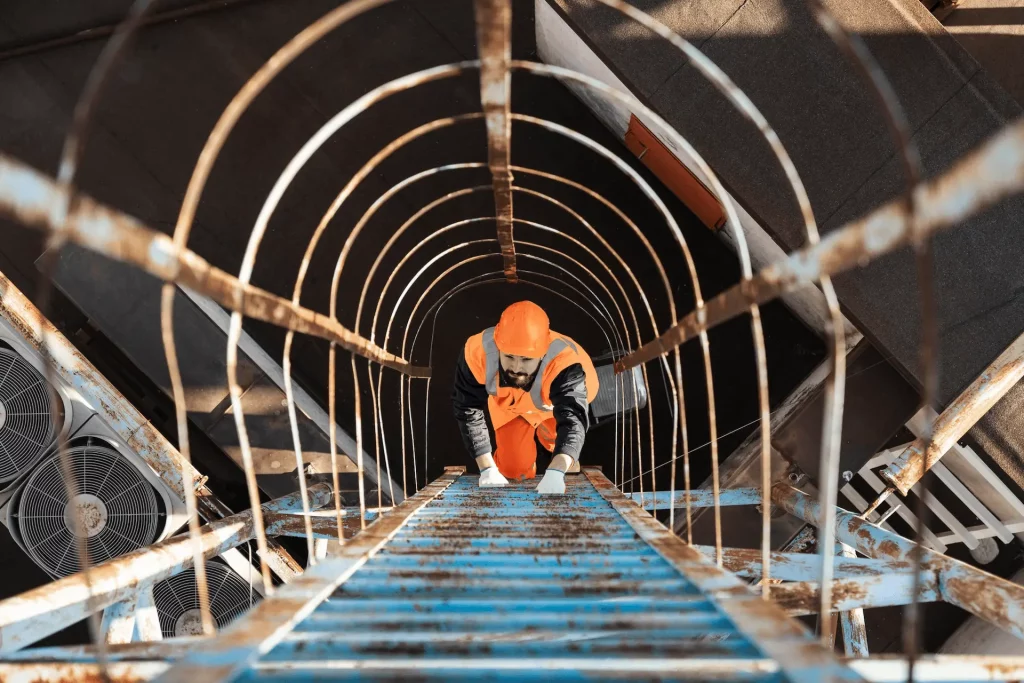Construction worker reviewing safety procedures to reduce workers' compensation risks