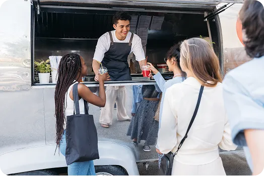 Food truck serving customers at an outdoor location.